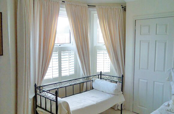 gorgeous childs bed with curtains behind