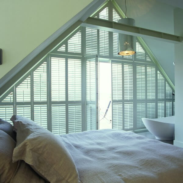 loft bedroom with stand alone bath