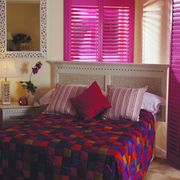 funky bedroom, bright colours and pink blinded doors